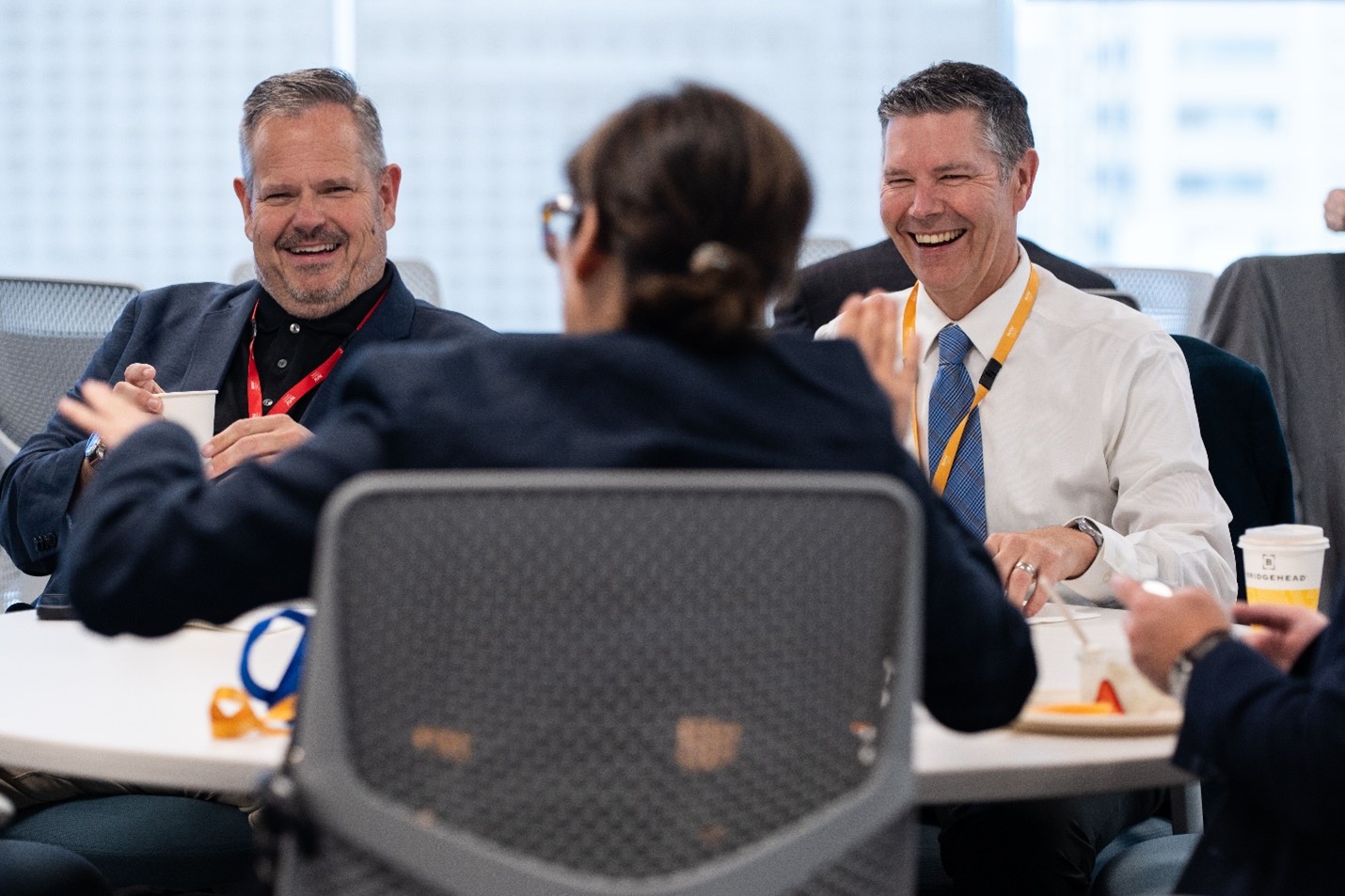 Two men laughing in focus.